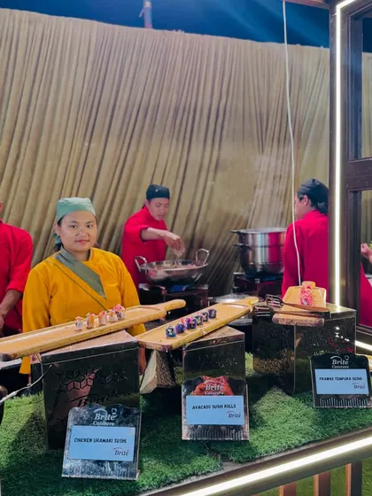 An overview of the bustling Japanese food station, where chefs prepare sushi and other delicacies for guests.