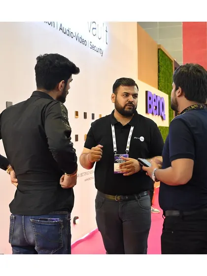 Our team is always ready to dive into the details. Here's a conversation happening at our product display wall.