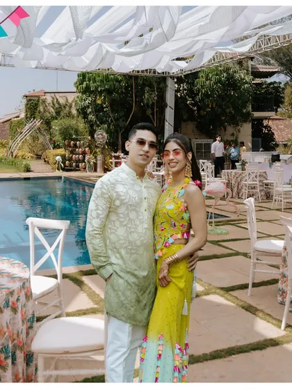 The happy couple enjoying their poolside Mehendi celebration. The relaxed, sunny vibe is perfect for creating candid and joyful memories.