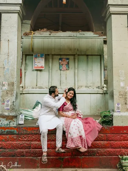 A sweet, candid moment as he places a flower in her hair during their pre-wedding session in Pune.