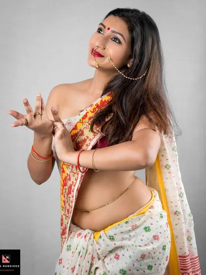 A dynamic pose capturing the grace of Indian dance. The model, in a traditional saree, forms a mudra with her hands, blending cultural expression with portrait photography.