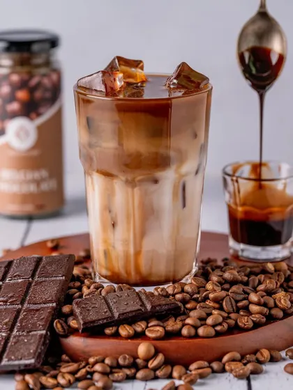 Capturing the final touch, a drizzle of chocolate syrup over an iced coffee. My goal is to photograph not just the drink, but the experience of enjoying it.