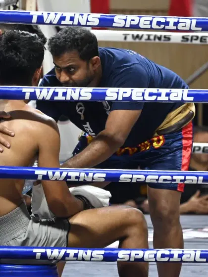 A coach giving instructions to his fighter between rounds. This corner work is crucial, providing strategy, motivation, and care when the fighter needs it most.