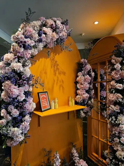 A beautiful floral arch in shades of lavender and pink against a bright yellow backdrop. This detail from the Sangeet decor shows our focus on creating picture-perfect photo opportunities throughout the venue.
