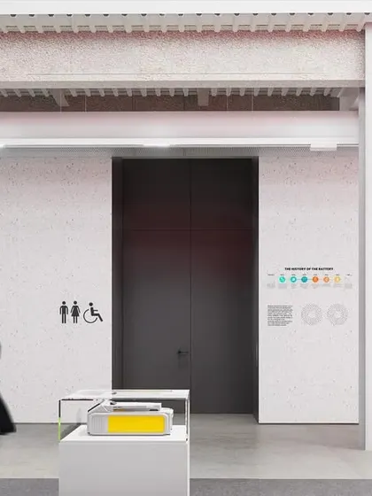 The interiors for the 'ePositive' research center are designed to be honest, unpretentious, and functional. This view shows the raw, industrial aesthetic with exposed beams and simple graphic elements, creating a space that is airy, open, and timeless.