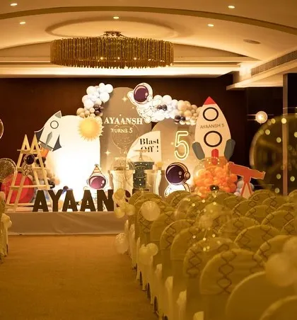 The complete venue setup for the space-themed party, with chairs arranged for a show or presentation. We handle all aspects of event layout and management.