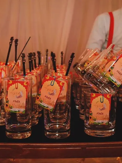 Personalized glassware ready for a welcome dinner. The custom tags with the couple's initials add a thoughtful and elegant touch to the celebration.