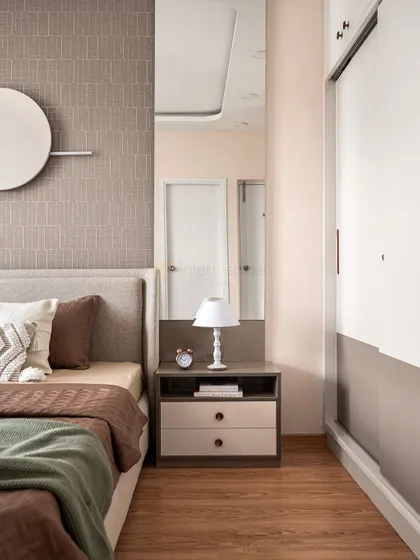 This view shows the bedside table with a full-length mirror beside it, a great way to add function and make the space feel larger. The sliding wardrobe is a space-saving solution.