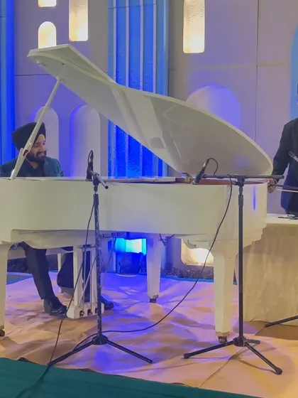 A wide shot of our instrumental trio setup with a grand piano, tarshehnai, and tabla, creating a visually stunning stage.