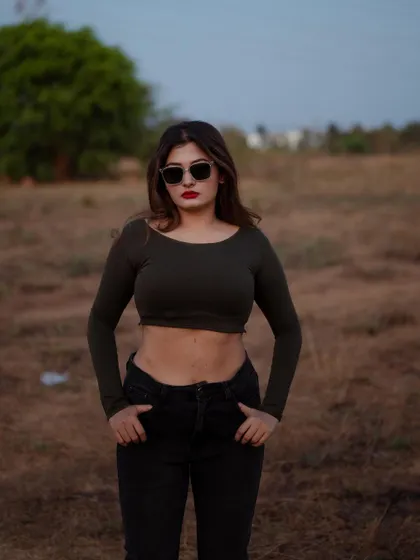A duplicate of image 192, this portrait captures a confident and moody look in an open field at dusk.