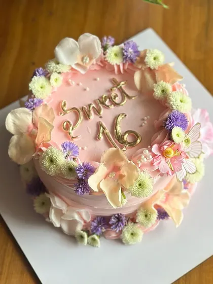 Pretty in petals. This minimal floral cake for a Sweet 16 is adorned with a wreath of fresh, delicate flowers for a celebration that is soft, sweet, and beautiful.