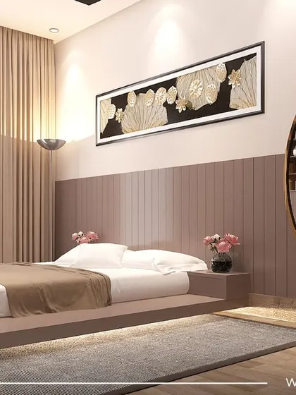 A bedroom from our 'Sobha Daisy' project, featuring a unique floating bed with under-lighting. The dusty rose color palette and large circular mirror create a soft, glamorous, and modern aesthetic.