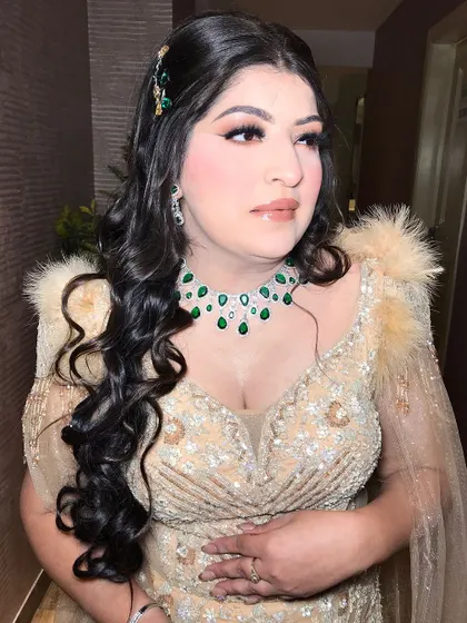 A close-up of the makeup, showing the soft smokey eye and nude lip.