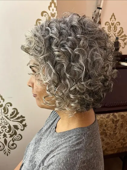 An asymmetrical curly pixie bob for Shilpa, designed to make the most of her beautiful silver curls.