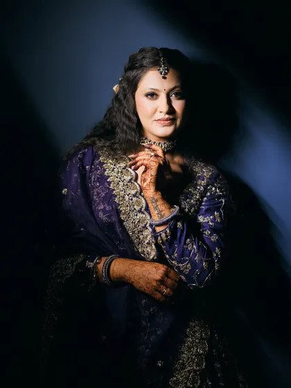 The full sangeet look, showcasing the intricate embroidery of the outfit and the elegant hairstyle.