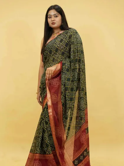 This dark green Bandhani print saree with a contrasting red border is a classic choice, now available as a 1-Minute Saree. It’s perfect for festive occasions and traditional ceremonies.