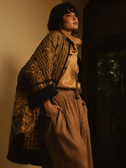A fashion portrait for House of Wandering Silk, using shadows and a doorway to create a moody and atmospheric shot.