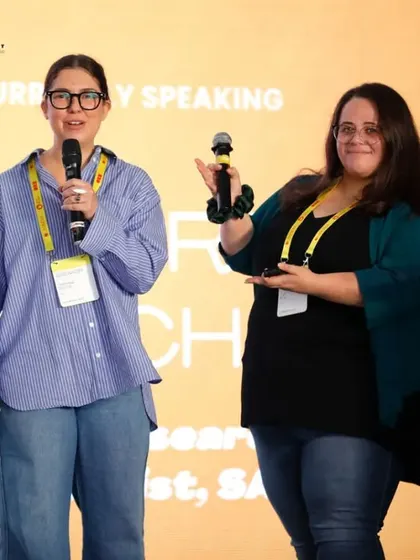 We cover interactive sessions and co-presenters with ease. This photo captures two speakers engaging with each other on stage at the UXINDIA conference, highlighting collaborative moments.
