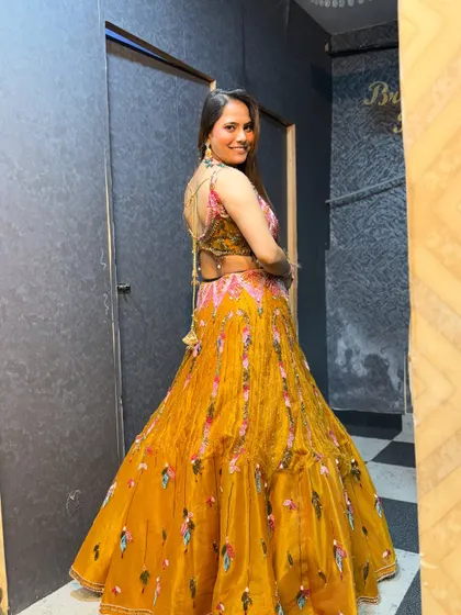 The back view of the yellow haldi lehenga, featuring a stylish back design.