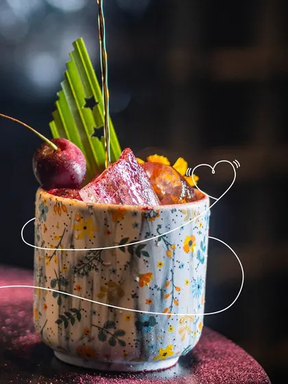 Wrapped around in love. This cocktail, with its floral ceramic cup and cherry garnish, is perfect for creating magical memories with someone special.