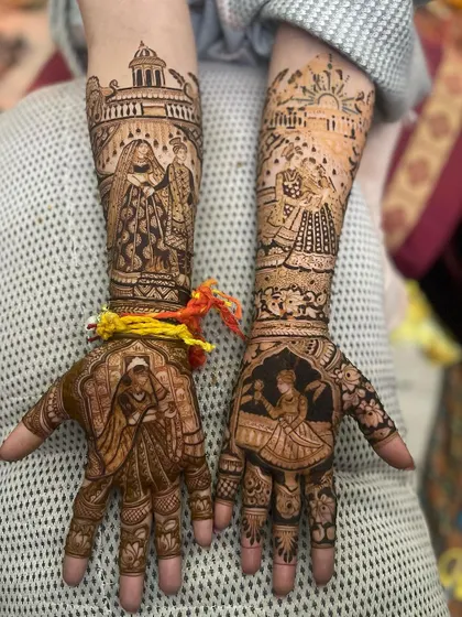 This intricate design tells a story with different scenes on each hand. One palm shows a bride in a doli, while the other shows her at a window.