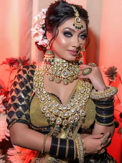 A striking portrait where the bride looks directly at the camera. Her hand gesture draws attention to her face and the magnificent statement jewellery she is wearing.