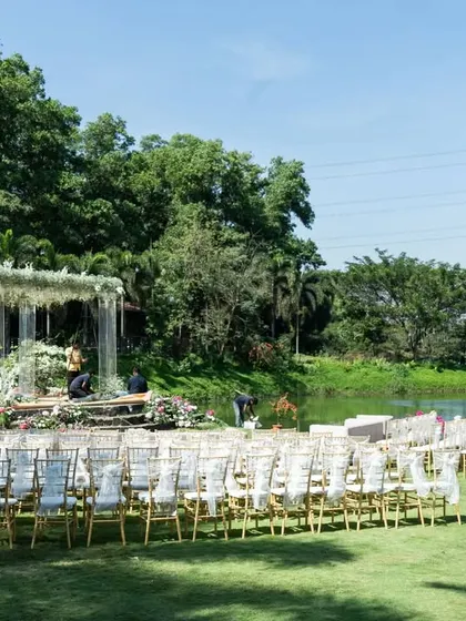The complete wedding setup by the lake, showing the guest seating arrangement leading to the stunning floral mandap, designed for a grand and scenic destination wedding.