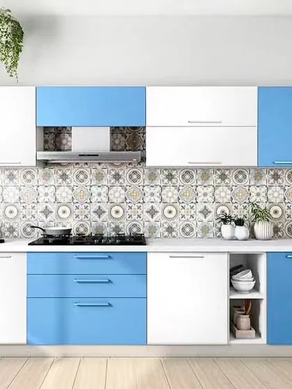A bright and modern straight kitchen with a blue and white color scheme. The patterned tile backsplash adds a decorative flair, tying the colors together beautifully.