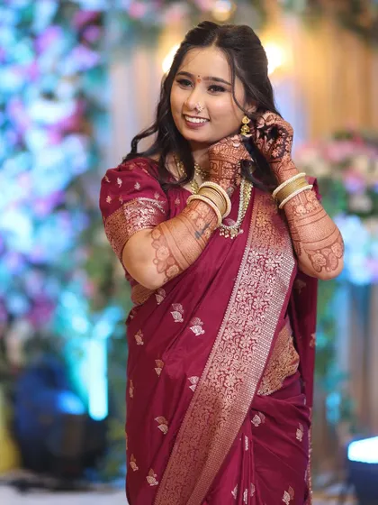 A candid moment of the bride getting ready. Her makeup looks flawless from every angle, highlighting her features beautifully.