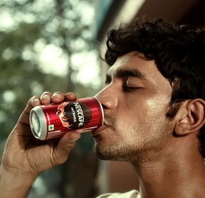 This shot from the Nescafé ad captures the simple pleasure of drinking a cold coffee. The character's relaxed expression and casual t-shirt enhance the scene's authenticity.