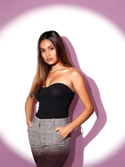 A more direct and powerful pose from the spotlight series. The model's hands in her pockets and strong stance project confidence.