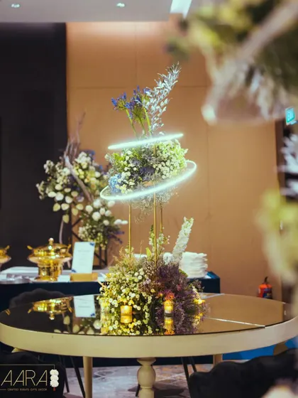 A centerpiece from the 'Gala Galaxy Night', where a floral arrangement is encircled by a glowing neon ring. This detail perfectly fused the bride's love for florals with the groom's passion for astrophysics.