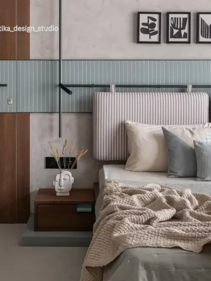 We used a mix of textures and materials in this bedroom to create a cozy, modern-Scandi feel. The design includes a striped upholstered headboard, a mint-green tiled accent wall, and warm wood paneling for a layered and inviting look.