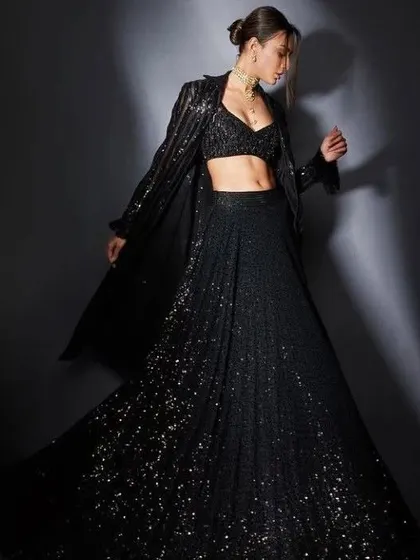 A black sequined lehenga with a matching jacket is the epitome of chic. This is a great inspiration for a sangeet or cocktail party outfit that I can customize for you.