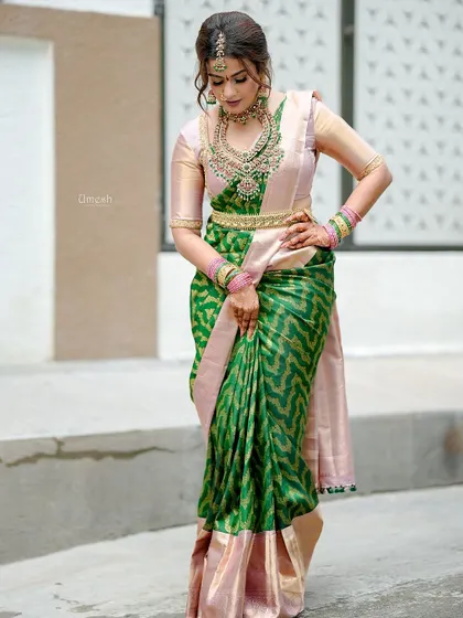 A poised and elegant shot, highlighting the beautiful silhouette created by the saree and the oddiyanam.