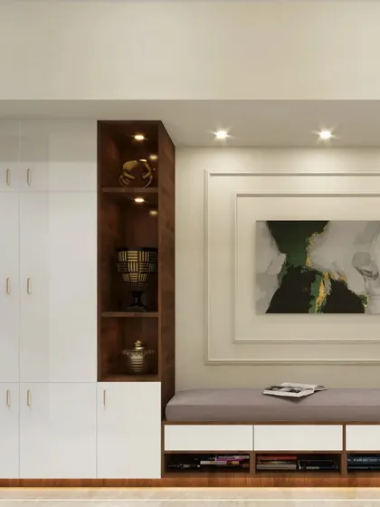 This foyer design combines function and style, with a comfortable bench seat, open storage for shoes, and a large cabinet, all in a clean white and wood finish.