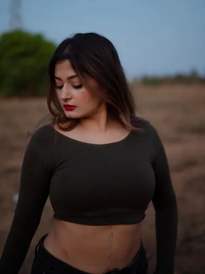 A duplicate of image 48, this close-up portrait at dusk highlights the model's features with soft, natural light.