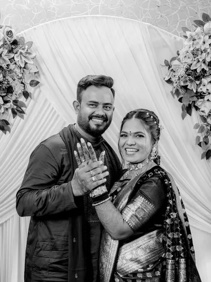A classic black and white portrait of a happy couple showing off their engagement rings. This style is timeless and focuses purely on the emotion of the moment.