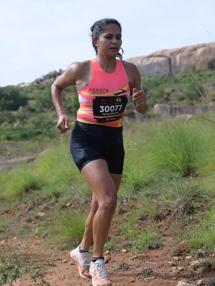 Focused and driving up an incline during a trail ultra. Hill running is a fantastic way to build strength and mental fortitude. My coaching includes specific workouts to make you a stronger climber.