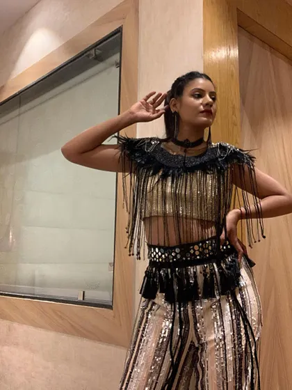 Striking a pose in my performance attire. The outfit is a key part of the storytelling, and this one was chosen to complement a fast-paced, celebratory dance routine.