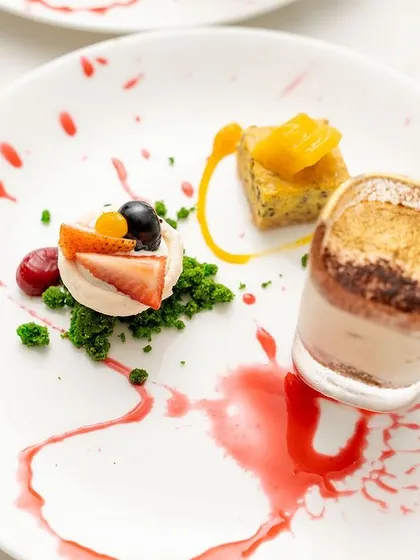 Dessert is art. This exquisitely plated dessert trio, featuring a mini tiramisu, was created for a special 50th birthday celebration.