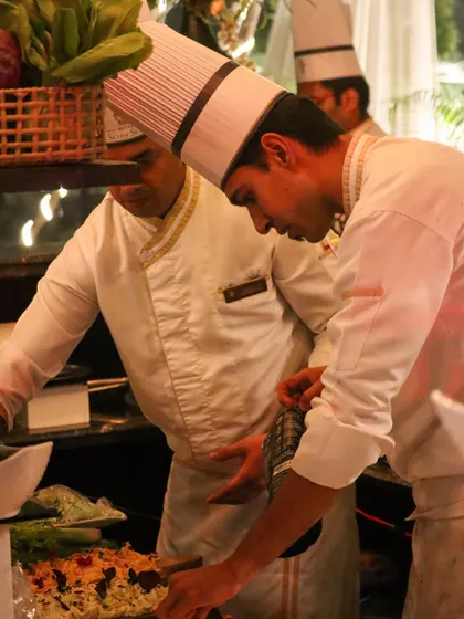 Two of our chefs collaborating at a live station. Teamwork and communication are key to our seamless service, ensuring every dish is executed flawlessly, even in a busy event environment.