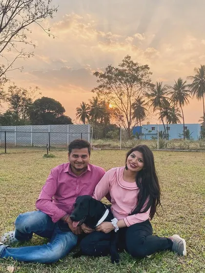 A beautiful sunset portrait of a couple and their dog, capturing a perfect memory.
