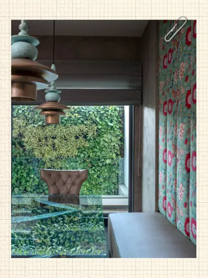At the Kumar Residence, we designed this cozy dining nook next to a lush green wall. The custom pendant lights and floral upholstered seating create an intimate space that feels connected to nature.