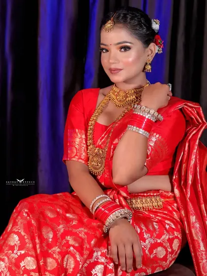 A seated portrait that captures the bride's elegance and poise. The way she is seated allows the beautiful drape of the saree to be fully appreciated.
