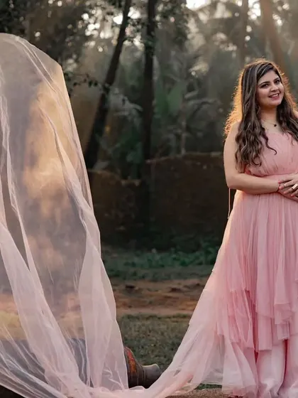 Golden hour light filtering through the peach net trail of the gown. This is the perfect dress for a soft, romantic, and whimsical pre-wedding or maternity shoot.