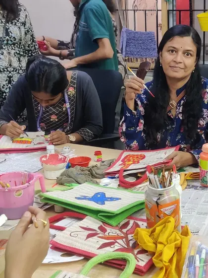 Me and other participants busy at work, painting our jute bags with bright, cheerful colors.