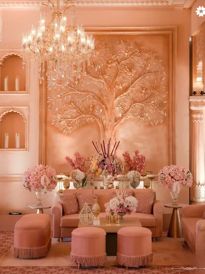 A lounge area from the 'Saanjh Niwas' wedding, featuring a stunning Tree of Life bas-relief. The decor is thoughtfully designed to create luxurious yet comfortable spaces for guests to converse and relax, with plush seating and soft, ambient lighting.