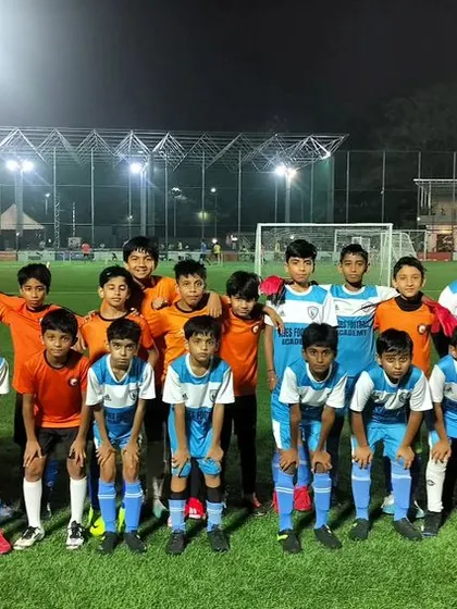 Players and coaches from both teams come together after a friendly match, fostering sportsmanship and community.