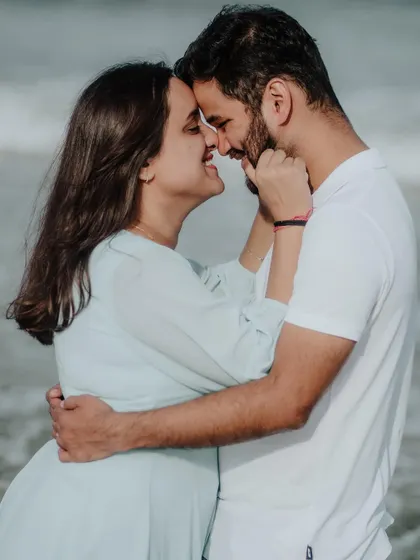 A playful and affectionate moment, capturing the fun and loving nature of the couple's relationship by the sea.
